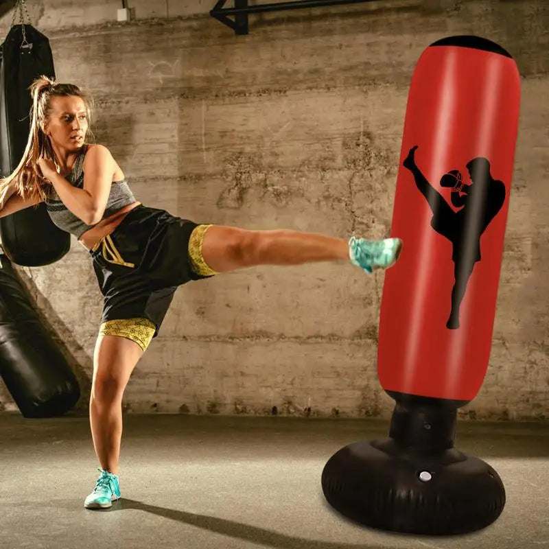Free-standing red and black punching bag with a black silhouette of a person kicking, used for Combat training.